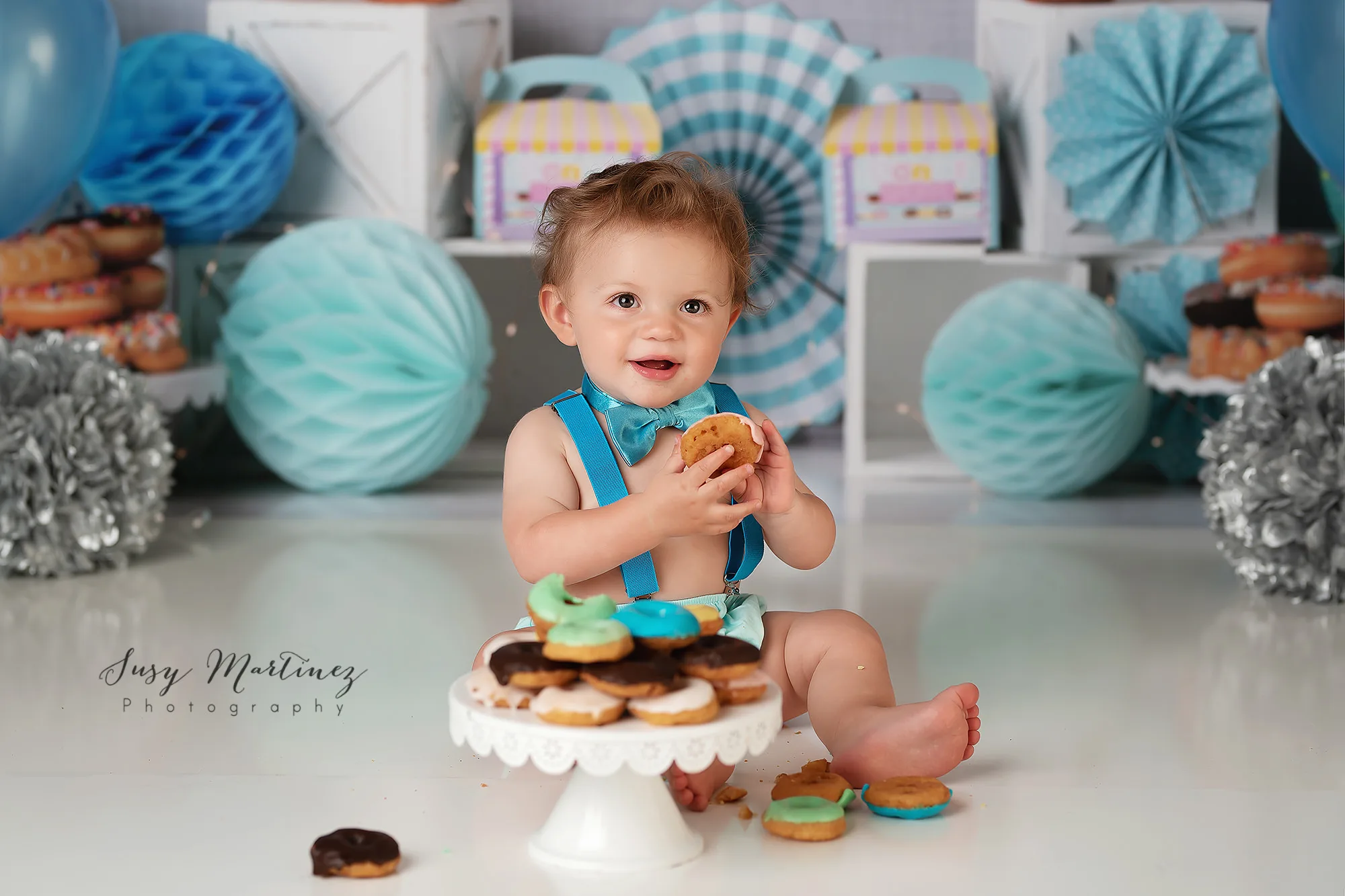 one year old eats pastel covered donuts during smash