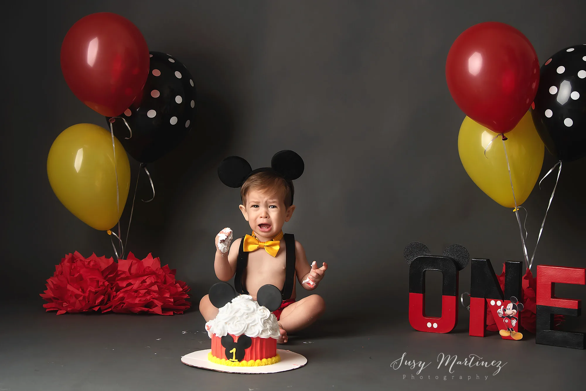 red, black, and yellow cake smash in Las Vegas studio