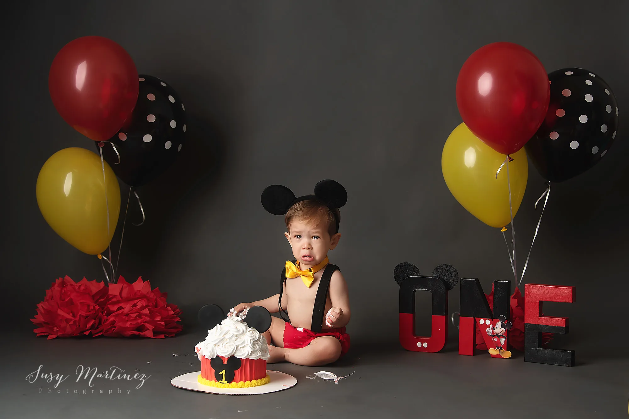 baby cries during Disney inspired cake smash