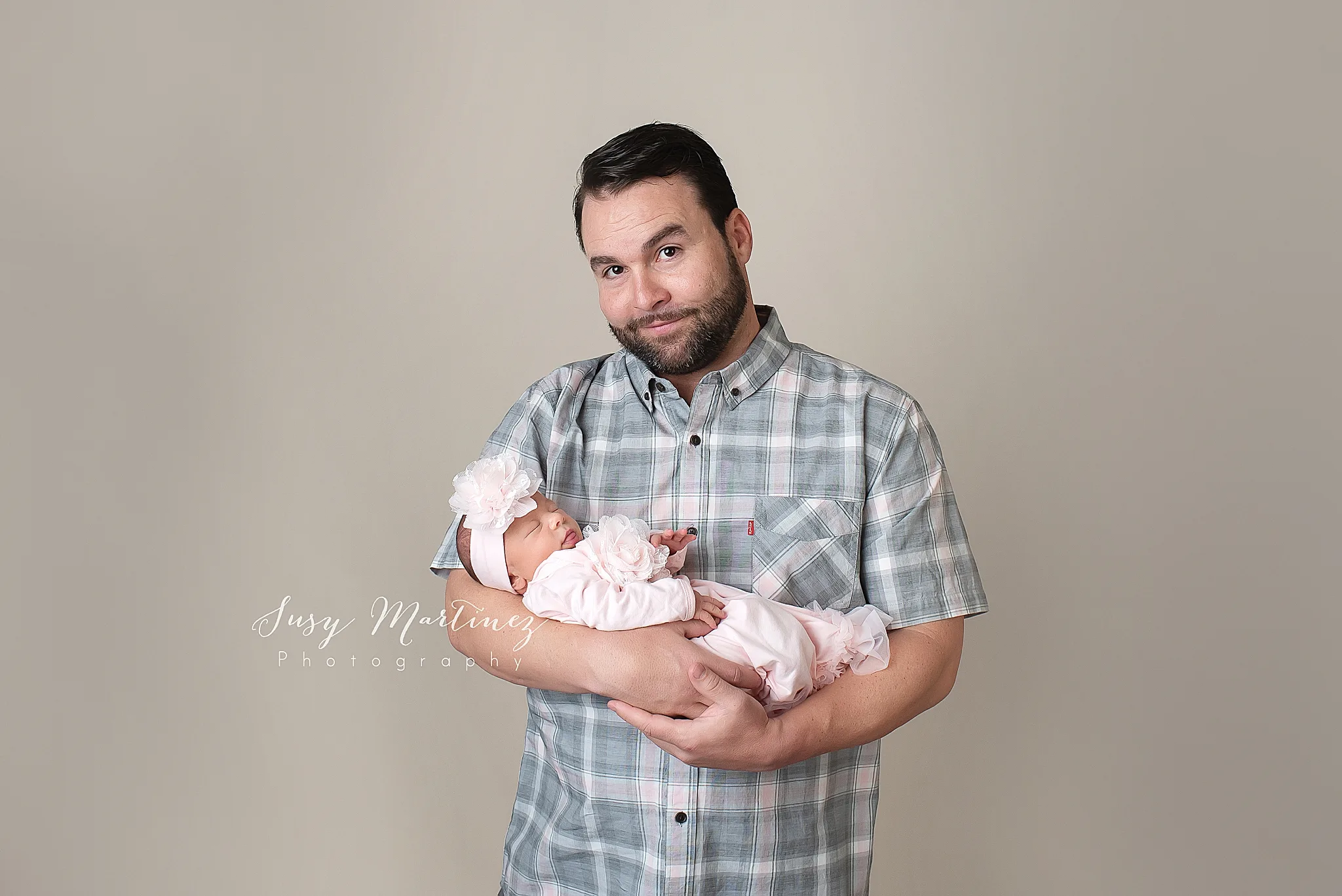 dad holds newborn baby girl during Las Vegas studio session