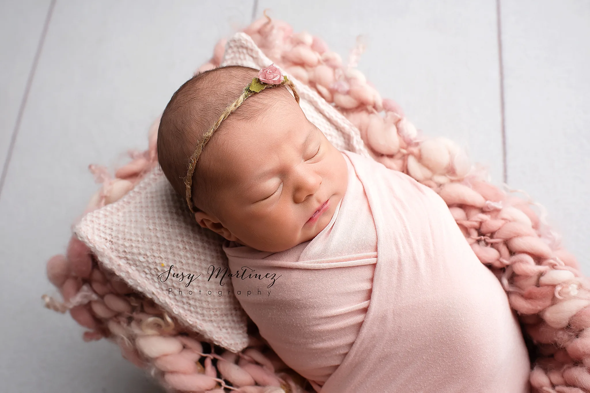 newborn baby girl in pastel setup during Las Vegas studio newborn session