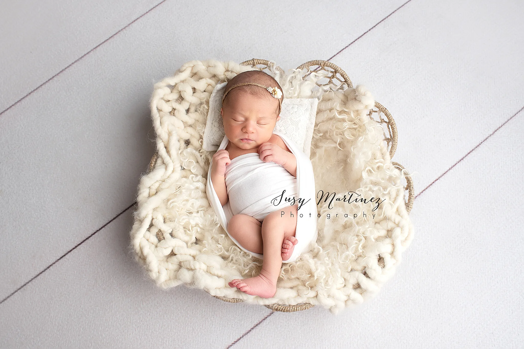 studio newborn portraits in Las Vegas of baby girl on ivory wrap