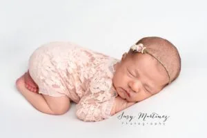 baby in lace floral outfit sleeps during Las Vegas newborn session