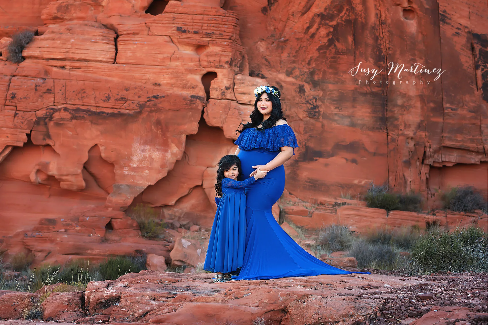 mom and daughter pose in blue Sew Trendy Accessories gowns during Valley of Fire Maternity Session