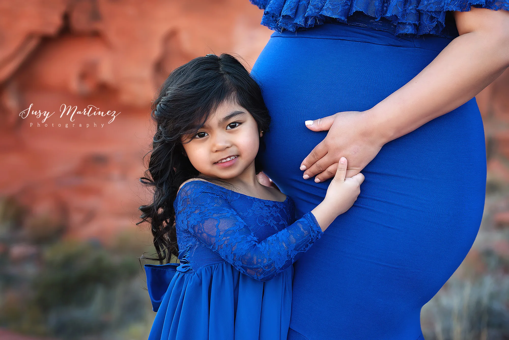 little girl hugs mom wearing matching Sew Trendy Accessories gowns