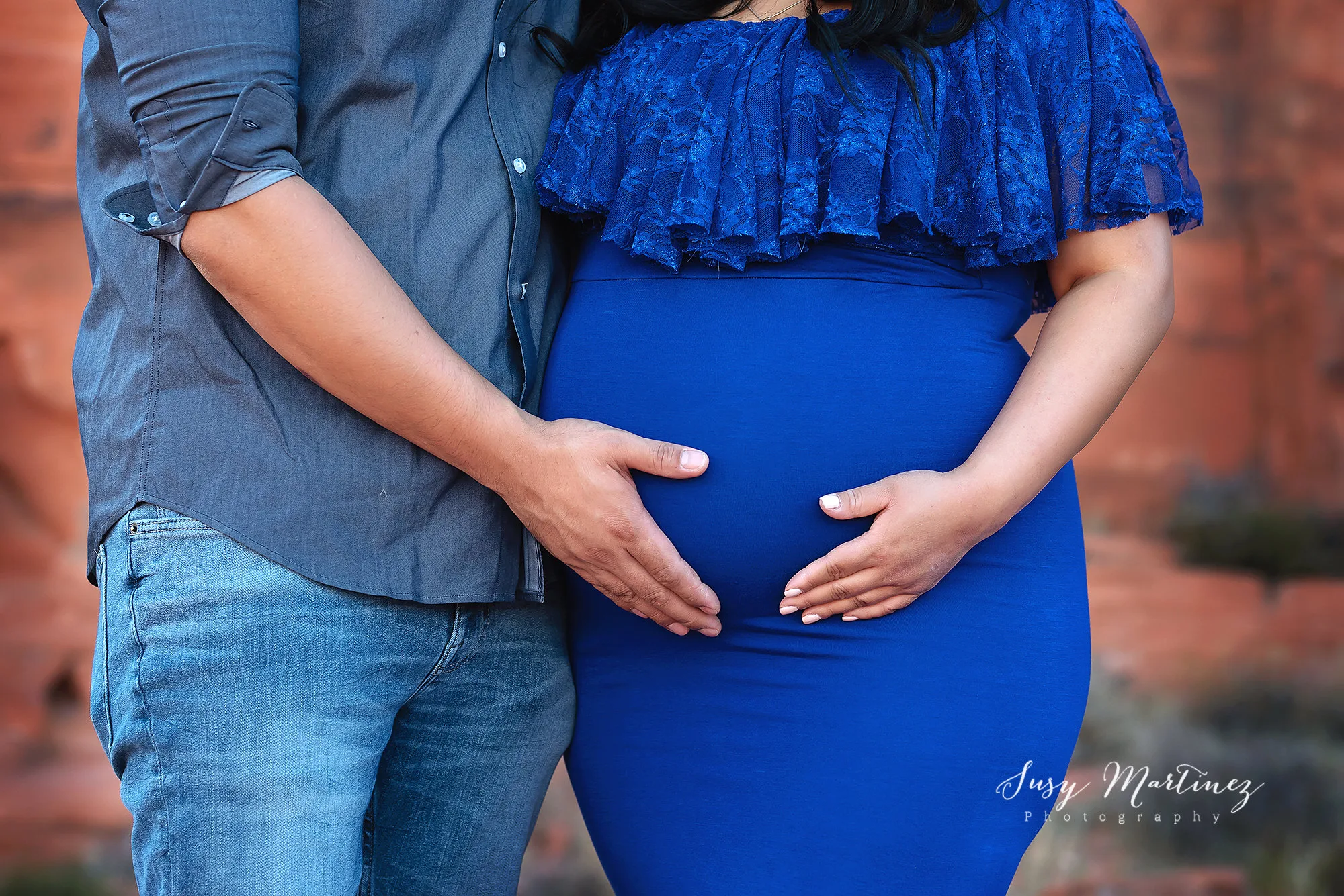 parents hold mom's belly during Valley of Fire Maternity Session