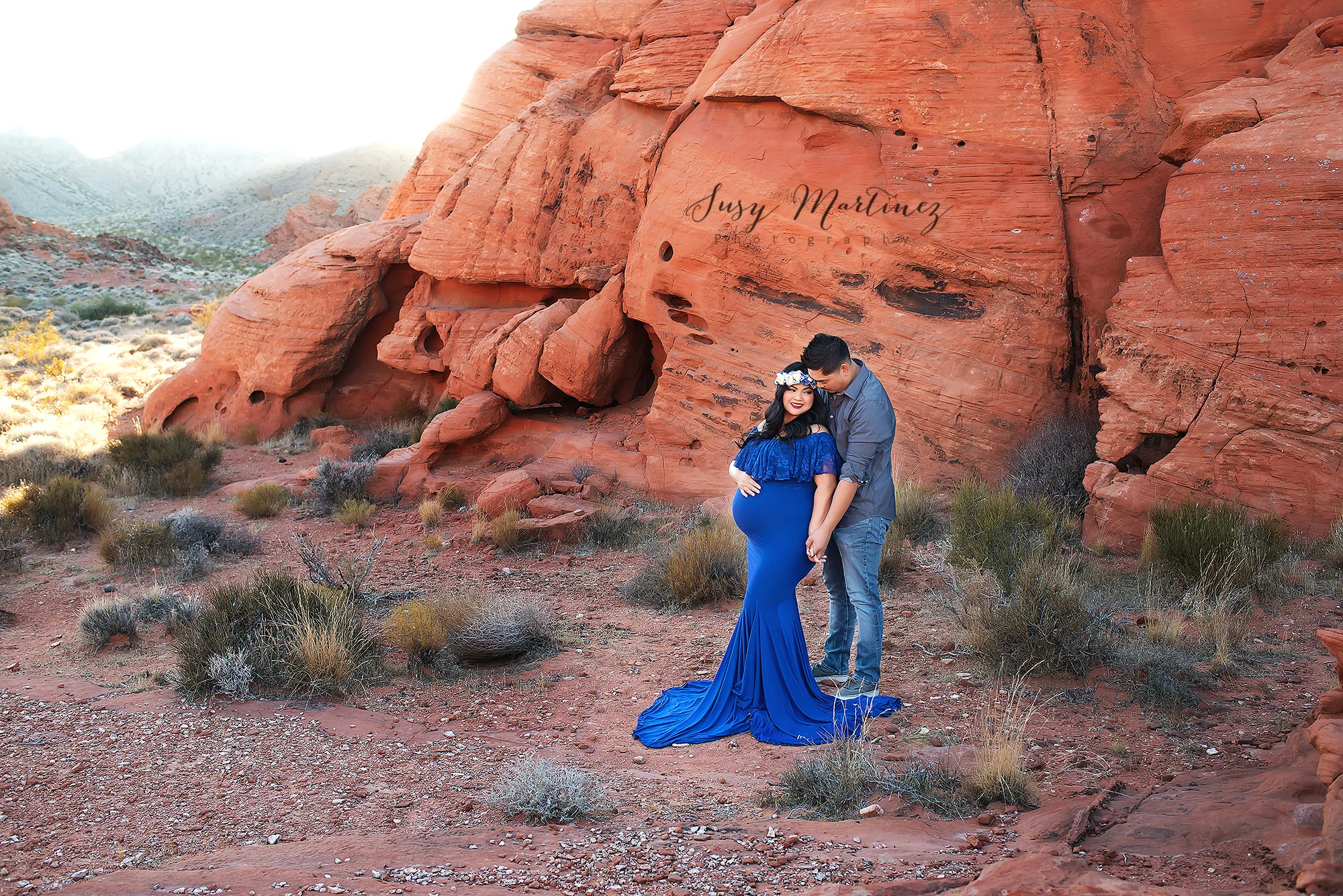 mom and dad pose by red rocks in Valley of Fire 
