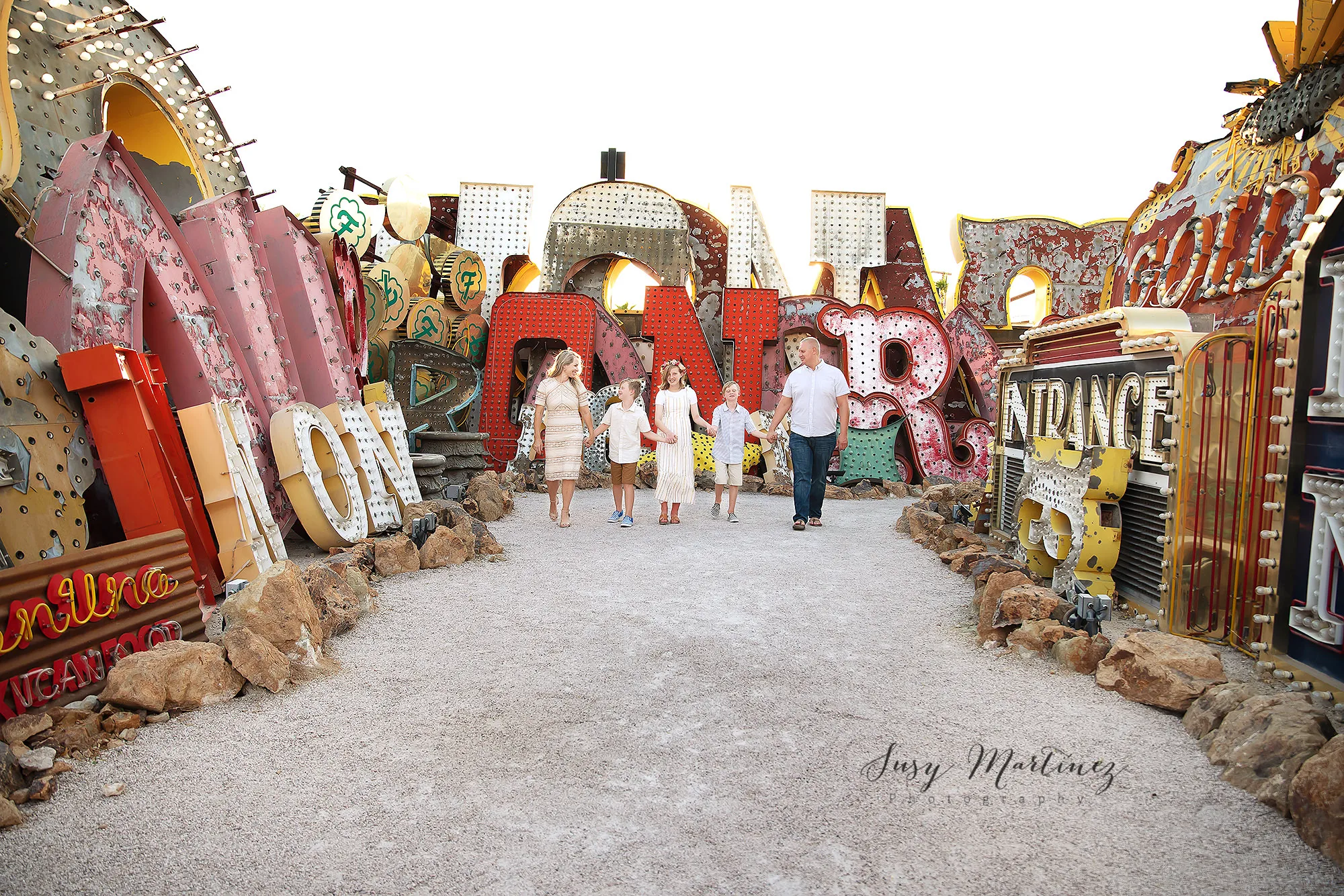 family of five walks through North Gallery in Las Vegas' Neon Boneyard