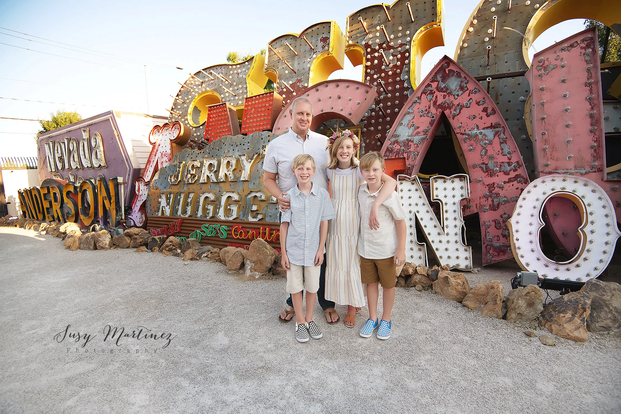 dad poses with three children during Neon Boneyard Family Portraits