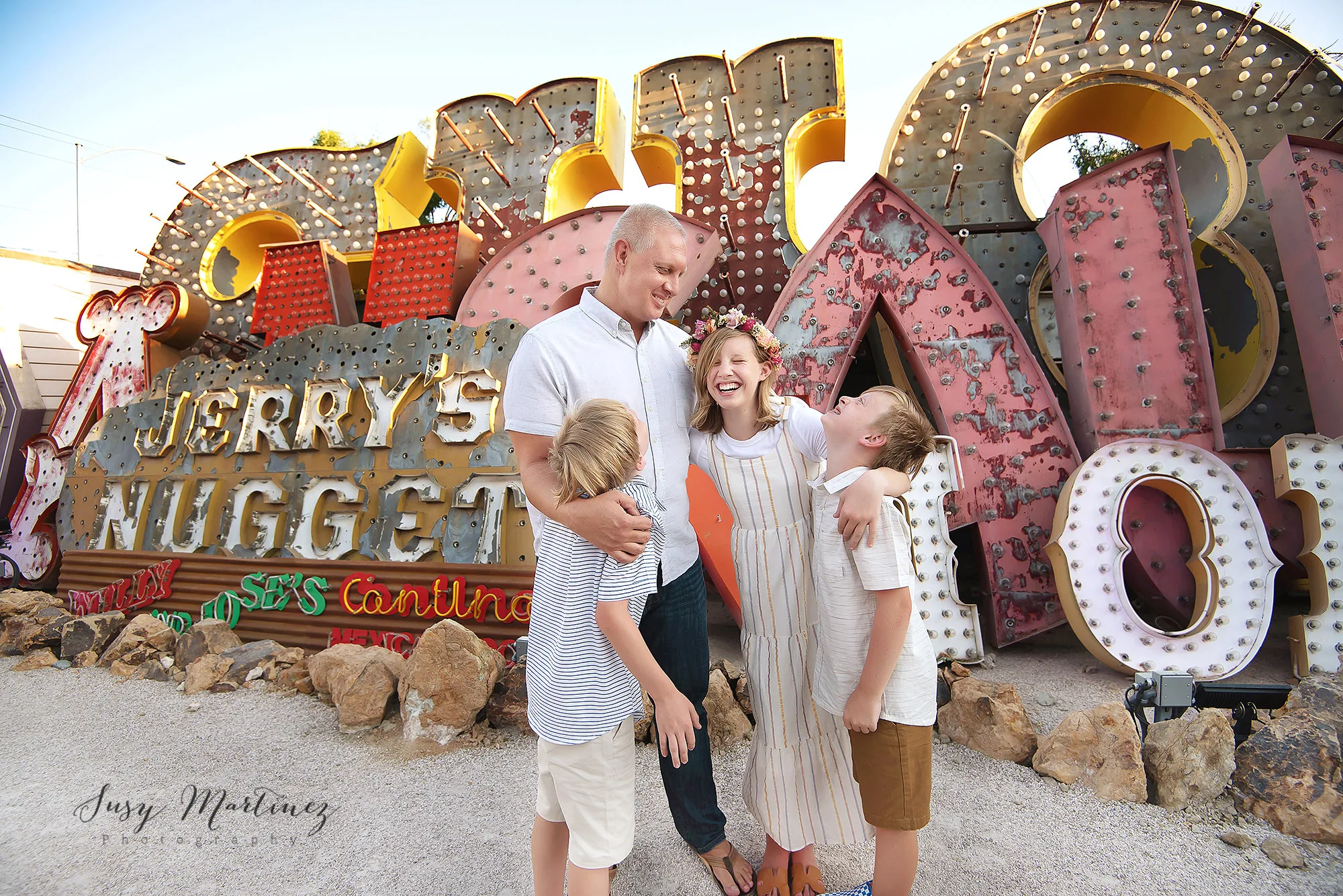 kids laugh with dad during family photos in Nevada