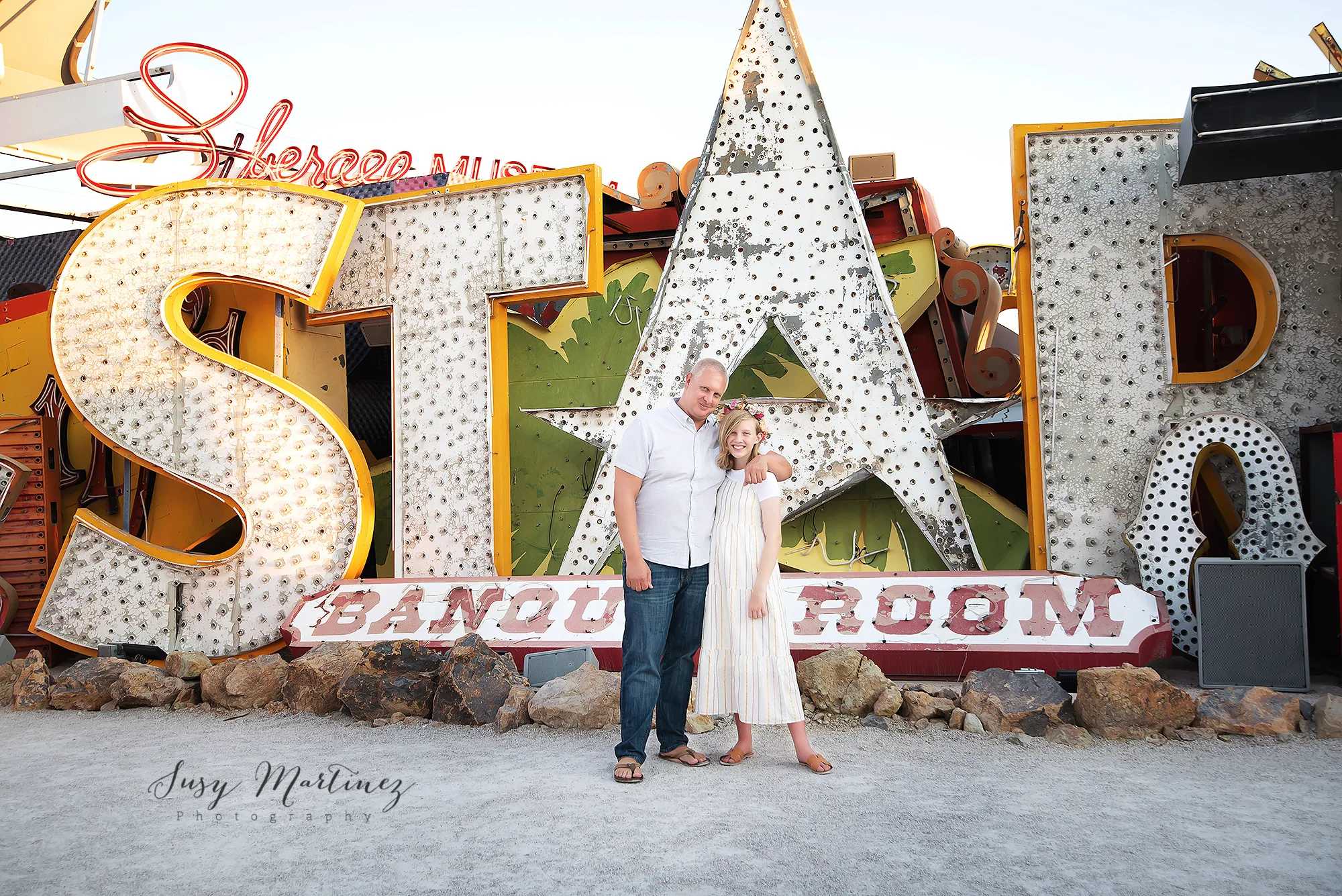 daughter hugs dad during Neon Boneyard Family Portraits