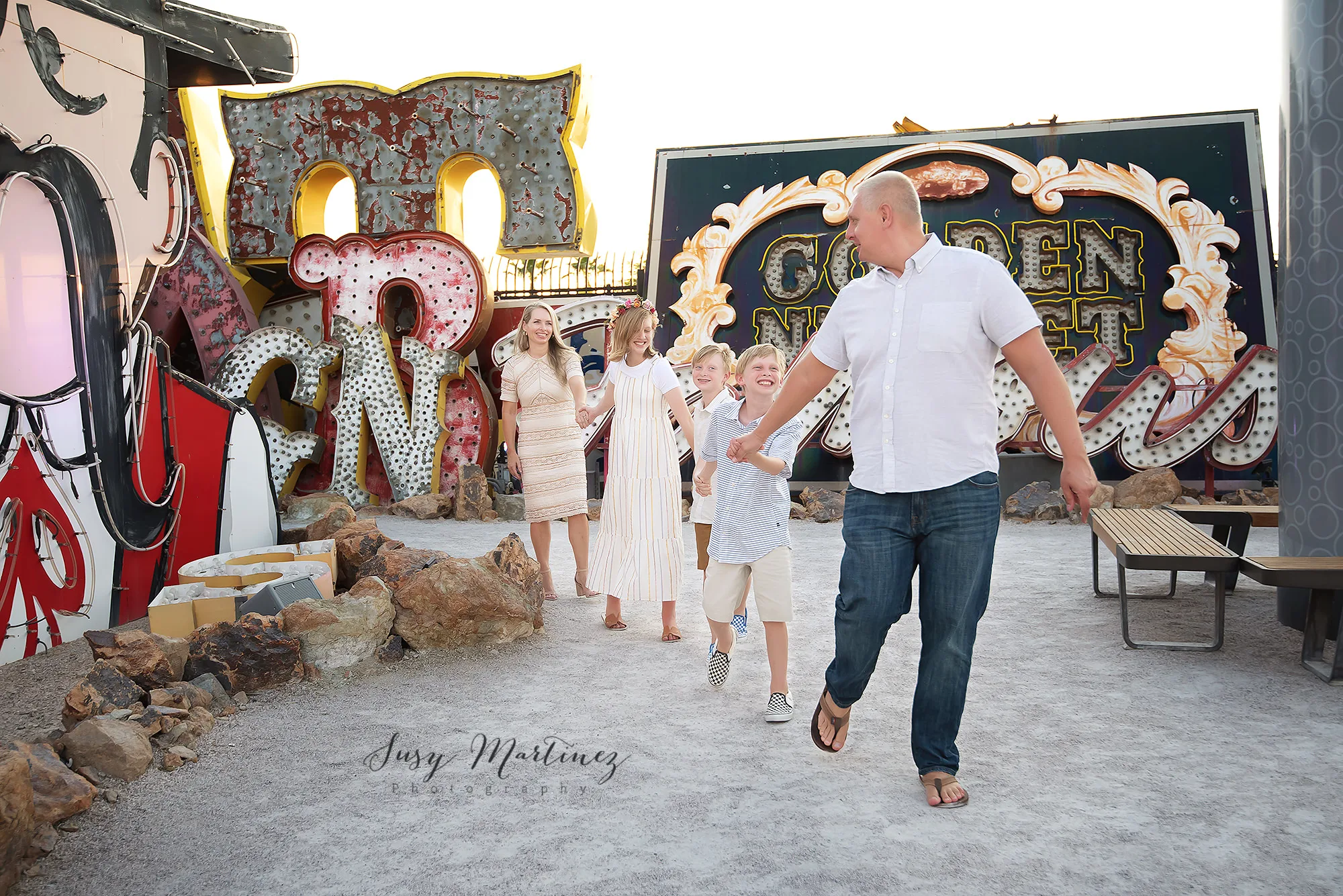 dad leads family through Neon Boneyard during family photos