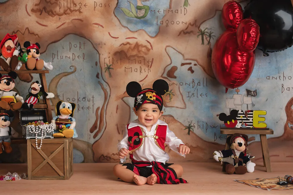 baby in pirate outfit plays during cake smash with Las Vegas photographer