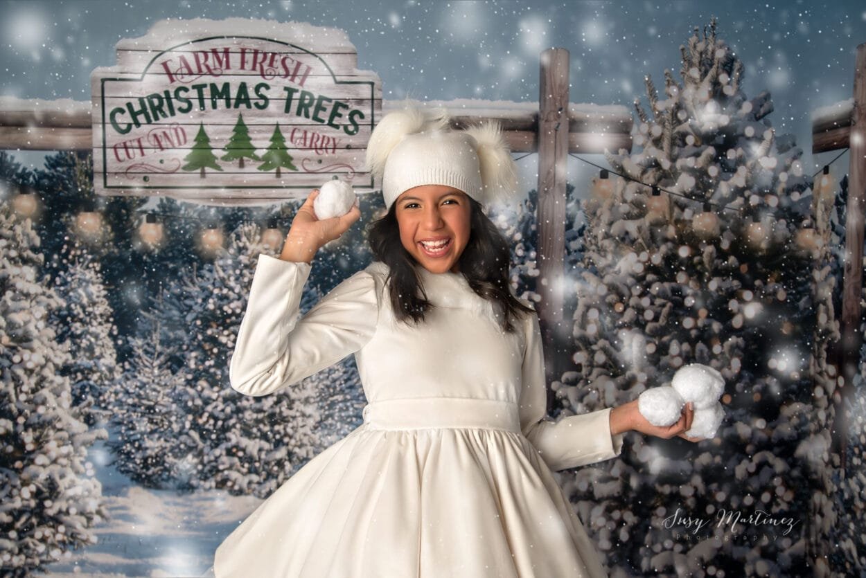 girl getting ready to throw a snow ball in a wintery snowy scene